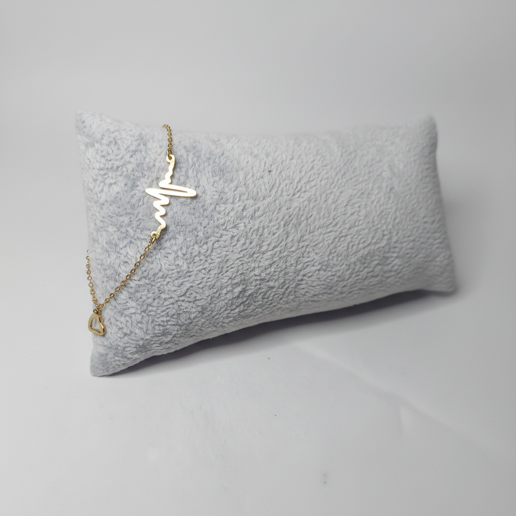 Gold Heartbeat Bracelet on Pillow - Side