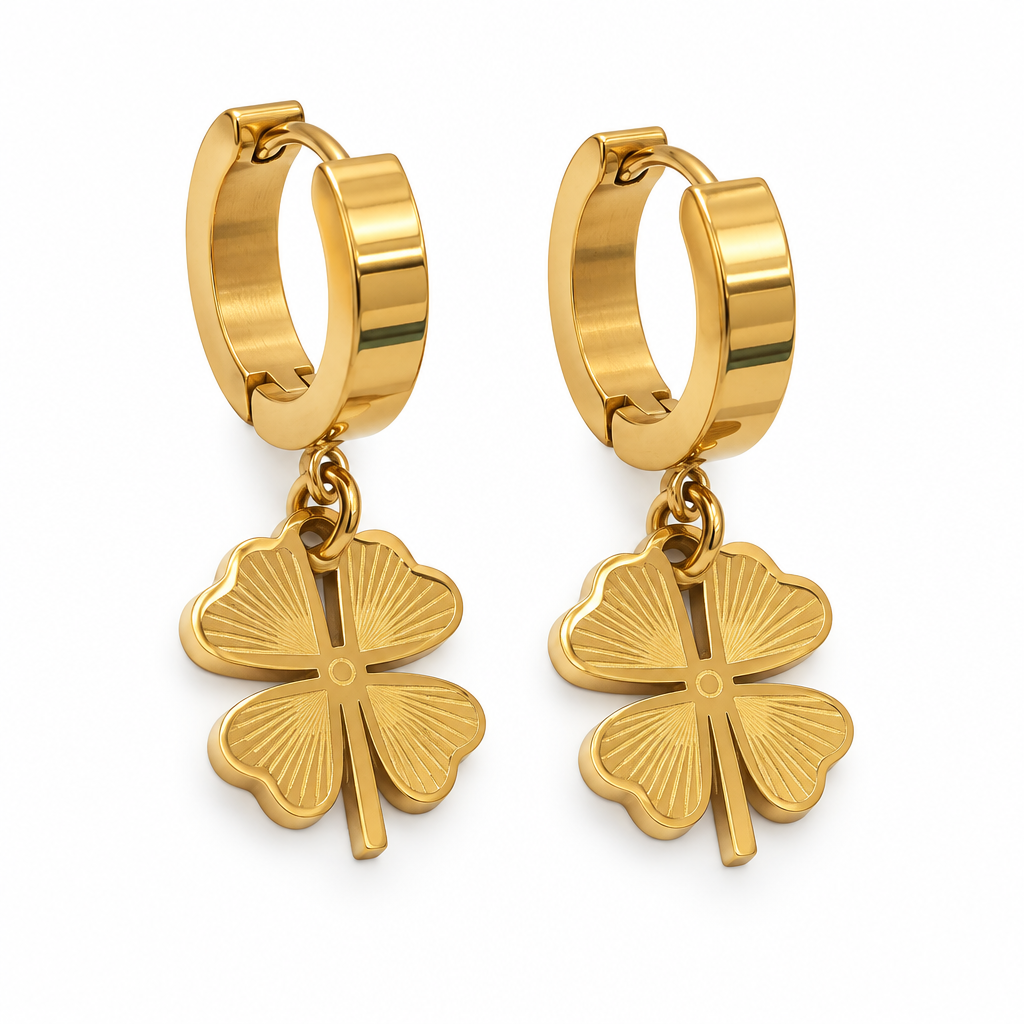 Gold clover charm hoop earrings on a white background