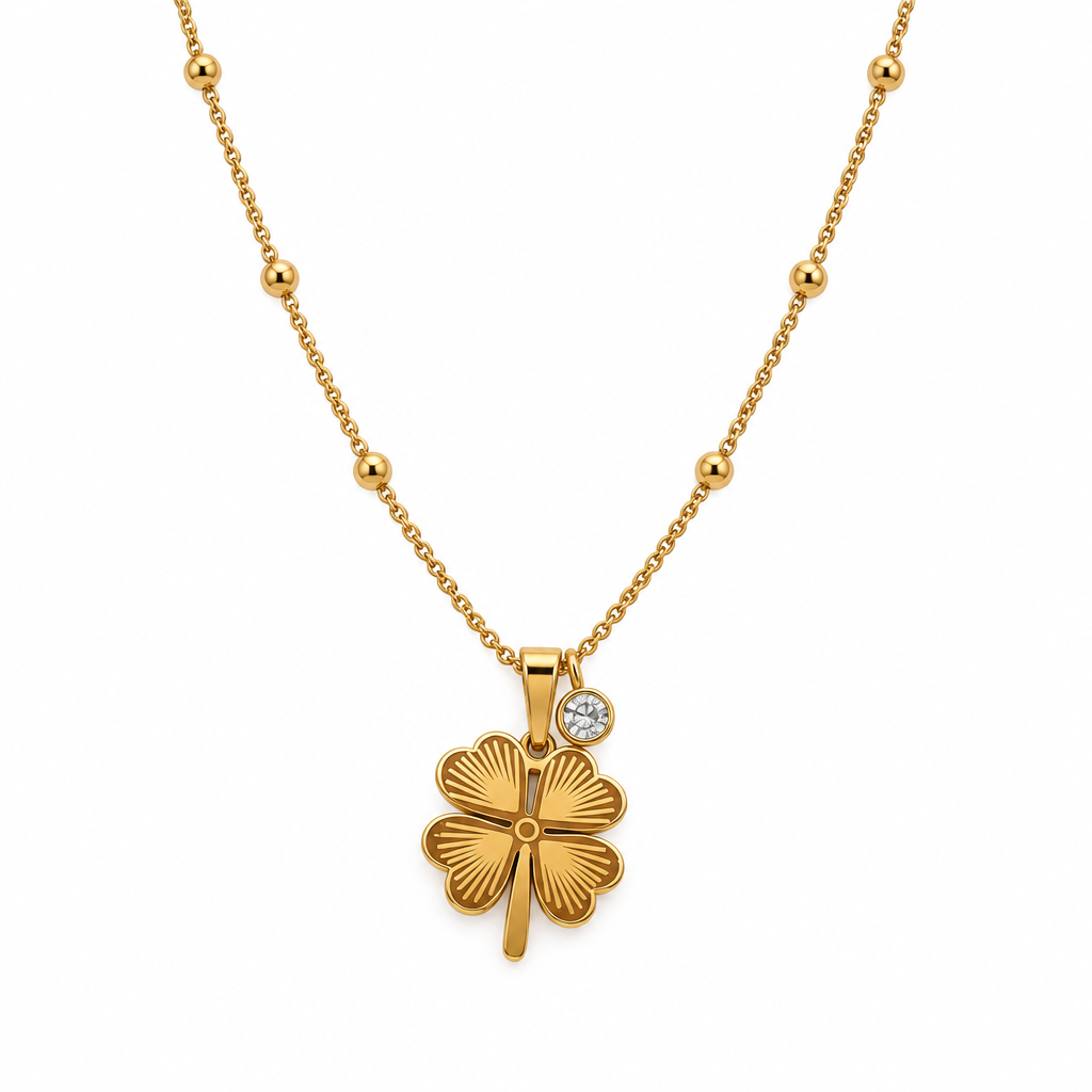 Gold-tone clover necklace with clear stone on a white background