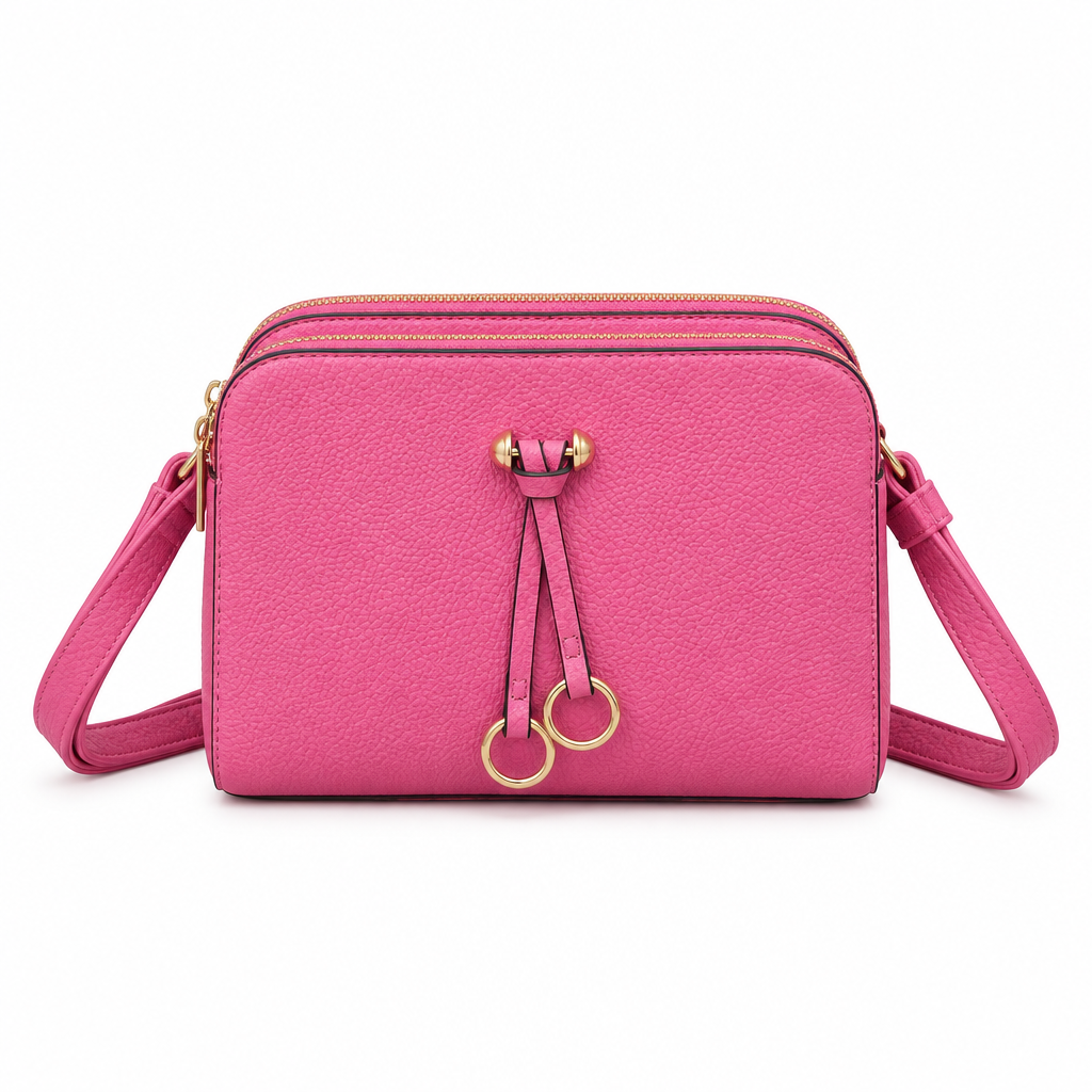 Bright pink crossbody bag with gold-tone ring details and matching strap on a white background